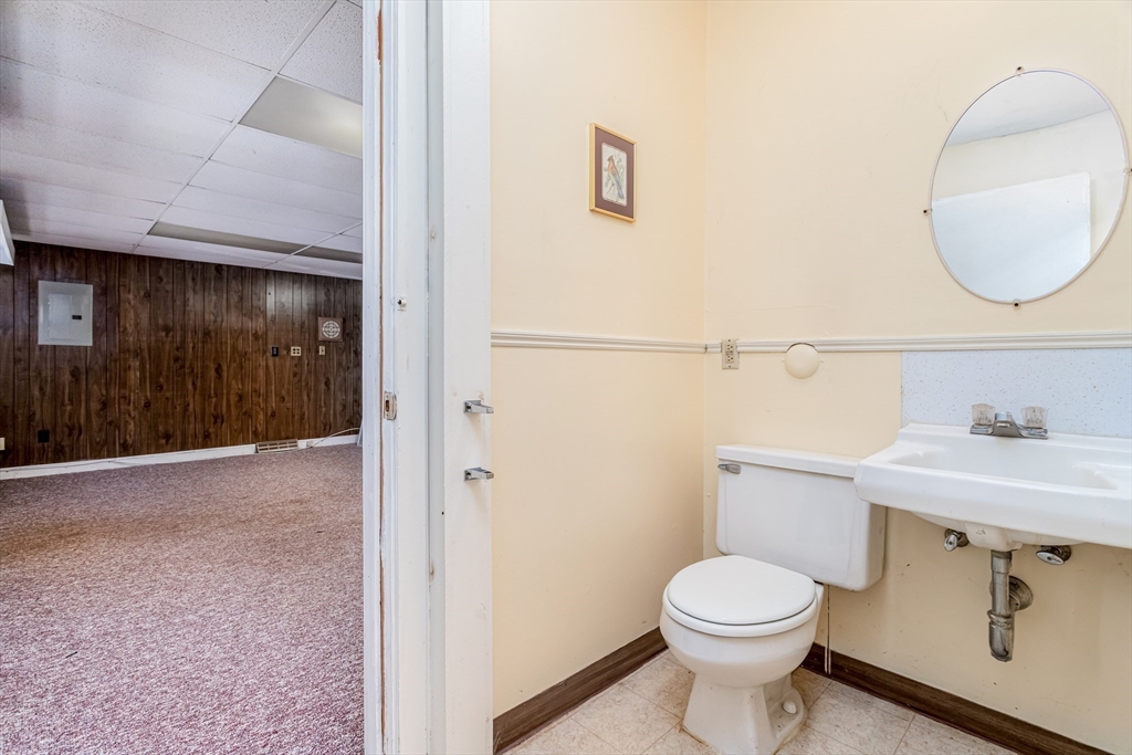 382 West Main Street Groton, MA 01450 - Photo 16 of 38 a bathroom with a toilet a sink and mirror
