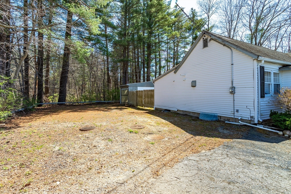 382 West Main Street Groton, MA 01450 - Photo 30 of 38 a view of a white house with a yard