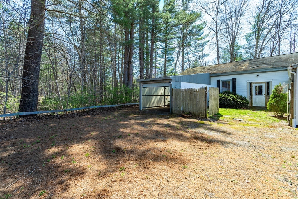 382 West Main Street Groton, MA 01450 - Photo 31 of 38 a view of a house with backyard and trees