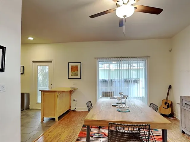 a view of a kitchen with fridge and wooden floor