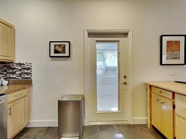 a room with wooden floor and windows