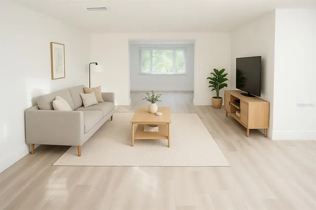 a spacious bedroom with a bed and a flat screen television