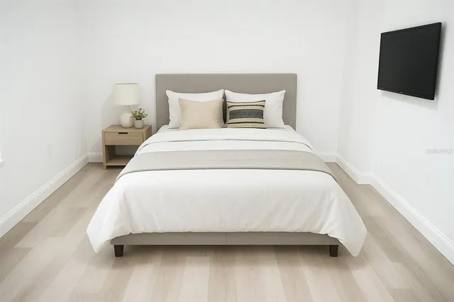 a bedroom with a bed and a window