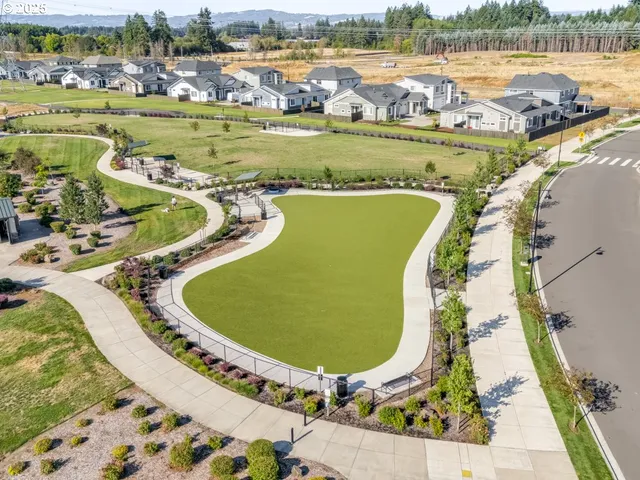an aerial view of a house with a swimming pool yard and lake view
