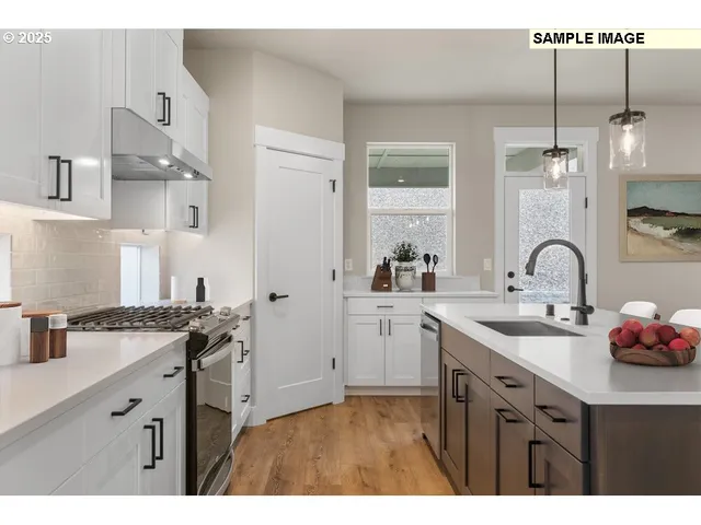 a kitchen with cabinets a sink and appliances