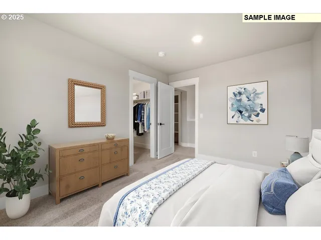 a bedroom with a bed and a potted plant