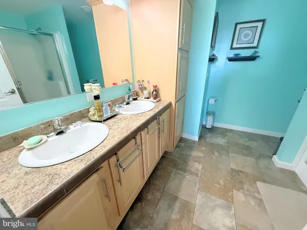a bathroom with a granite countertop sink a mirror and a bathtub