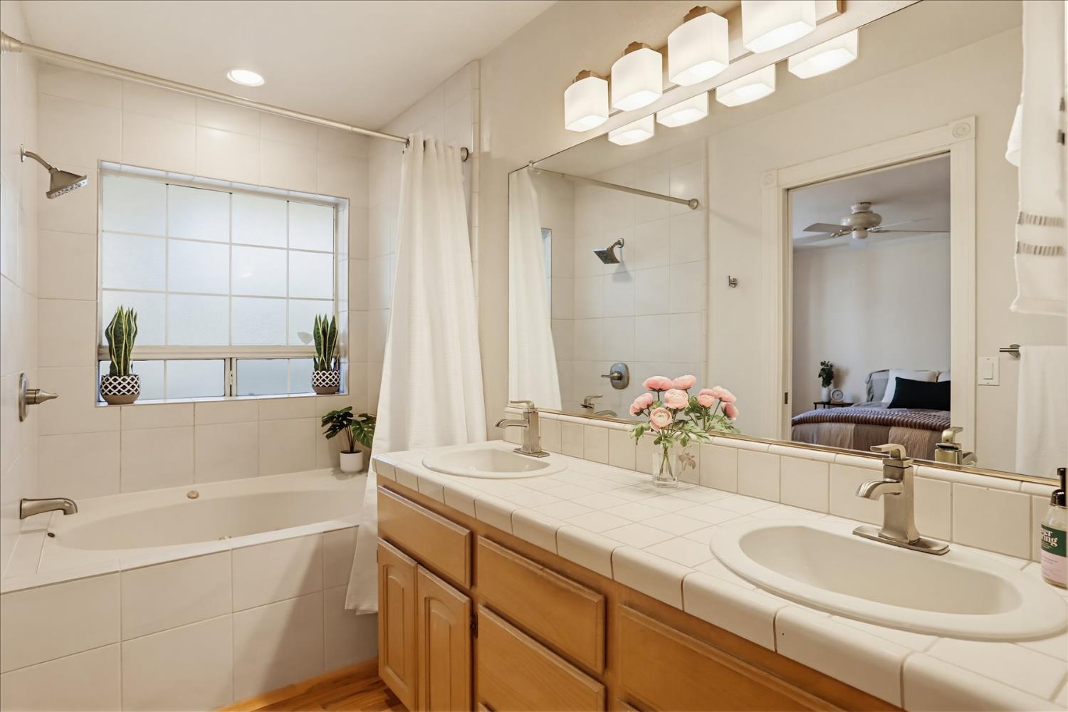 21324 Oak Ridge Drive Grass Valley, CA 95945 - Photo 12 of 32 a bathroom with a tub a sink double vanity and shower