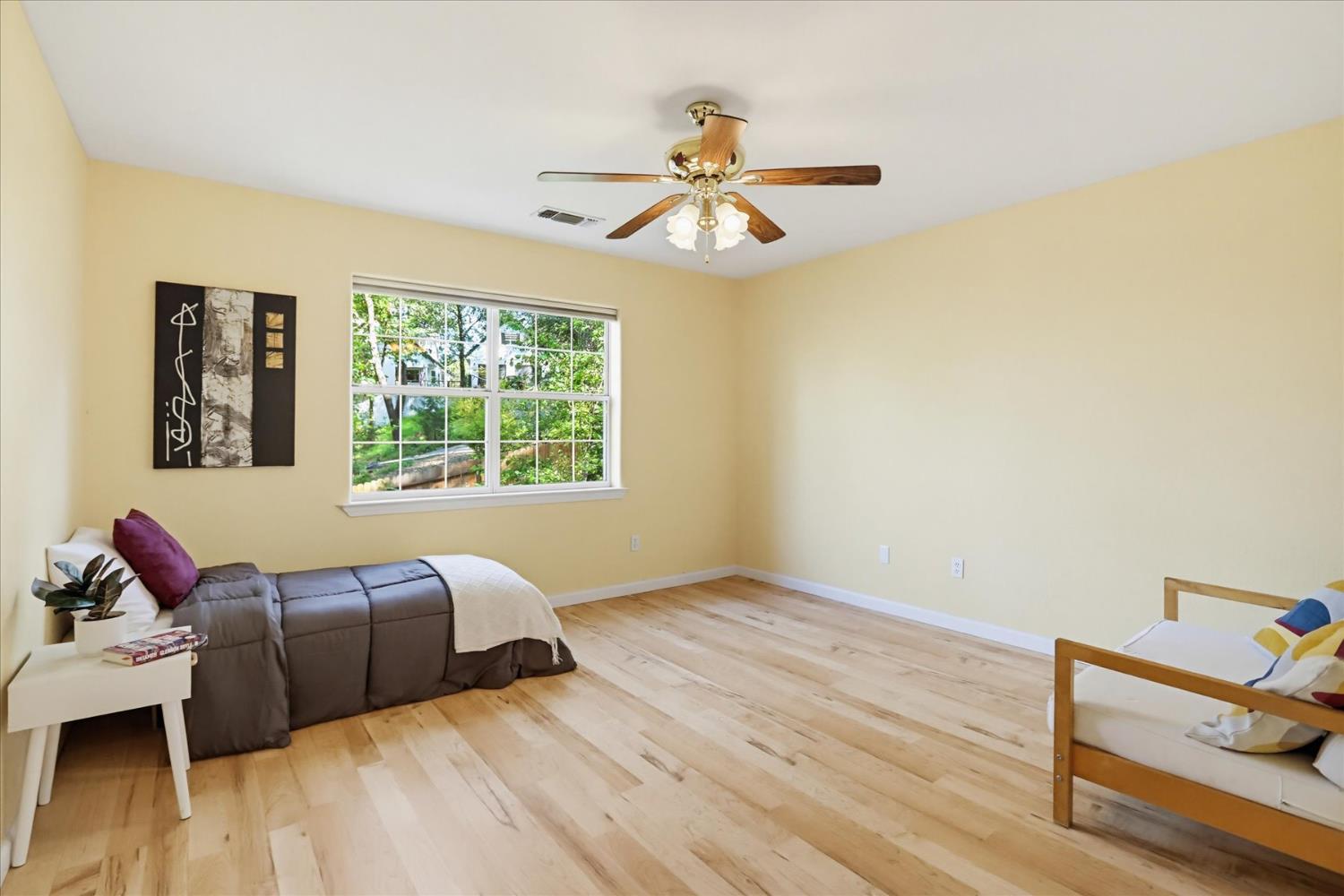21324 Oak Ridge Drive Grass Valley, CA 95945 - Photo 17 of 32 a bedroom with a bed and wooden floor