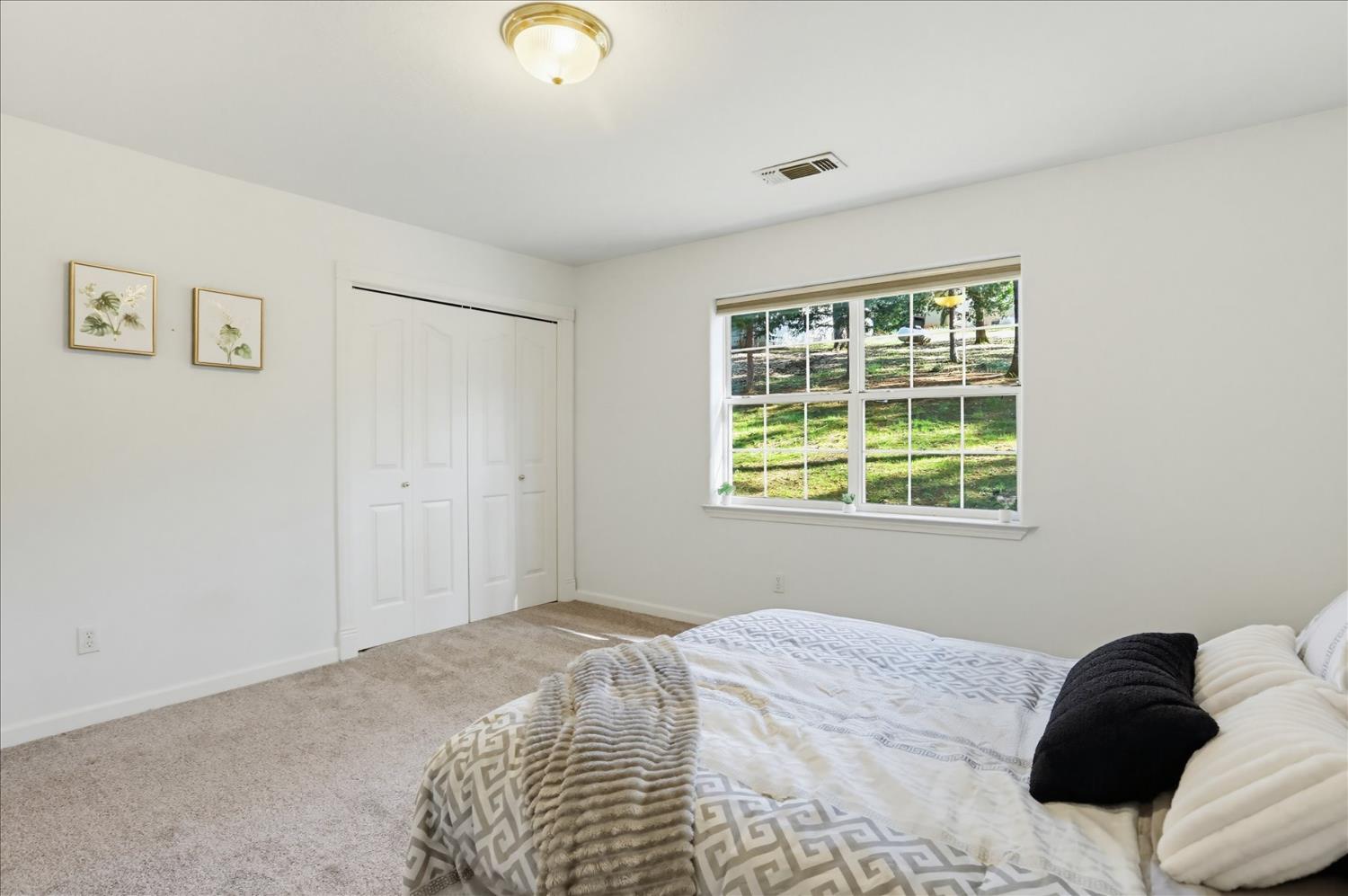 21324 Oak Ridge Drive Grass Valley, CA 95945 - Photo 21 of 32 a bedroom with a bed and a window
