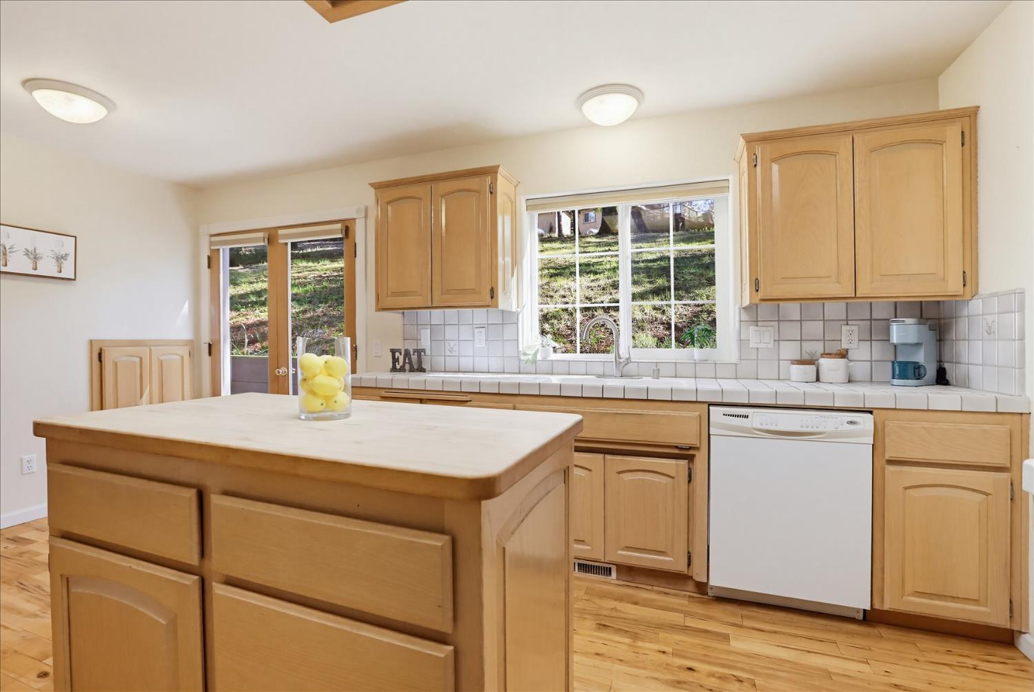 21324 Oak Ridge Drive Grass Valley, CA 95945 - Photo 9 of 32 a kitchen with a stove a sink and a window