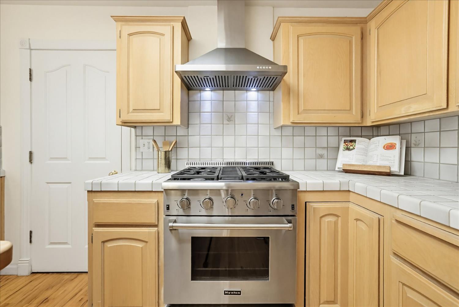 21324 Oak Ridge Drive Grass Valley, CA 95945 - Photo 10 of 32 a stove top oven sitting inside of a kitchen