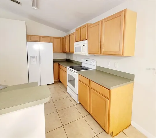 a kitchen with a sink cabinets and appliances