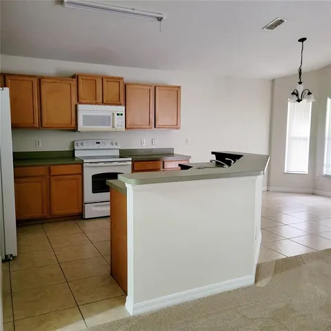 a kitchen with stainless steel appliances a sink stove and refrigerator