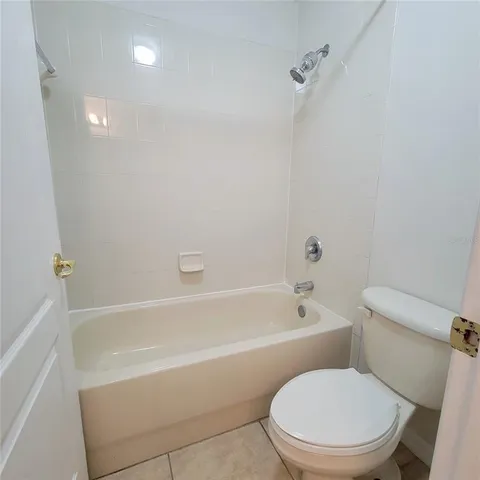 a white toilet and tub sitting next to a bathroom sink