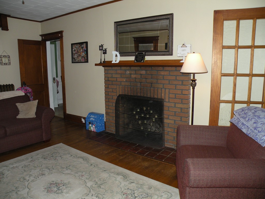 114 Brunswick Street Springfield, MA 01108 - Photo 5 of 15 a living room with furniture and a fireplace