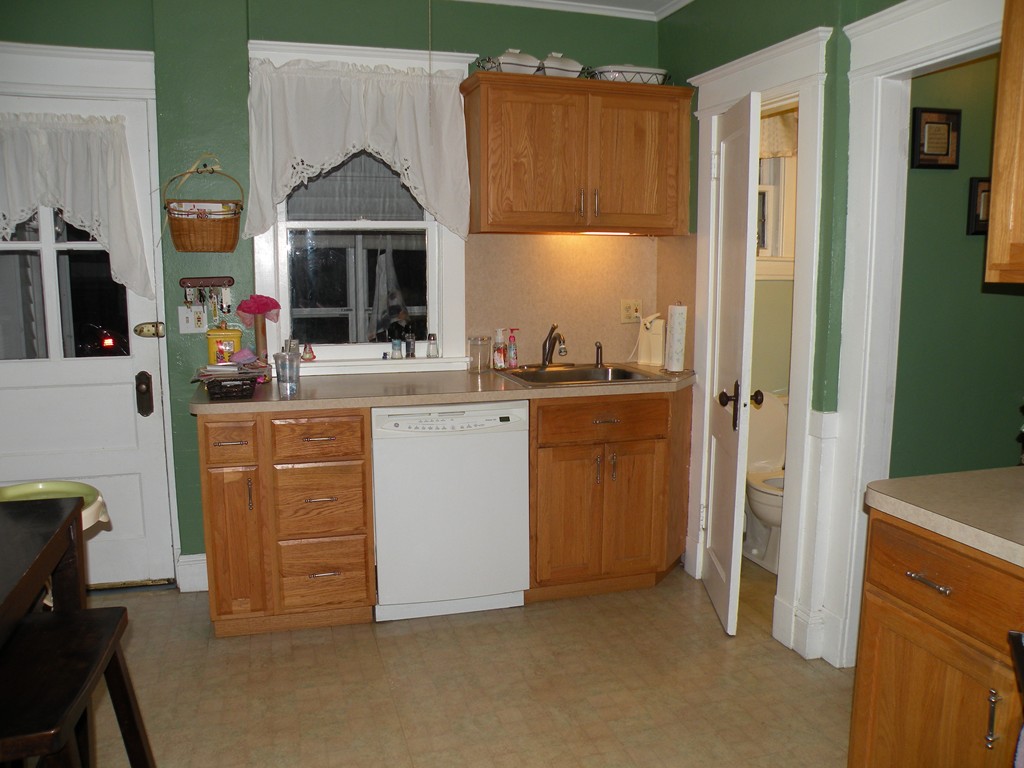 114 Brunswick Street Springfield, MA 01108 - Photo 8 of 15 a kitchen with cabinets a sink and a refrigerator