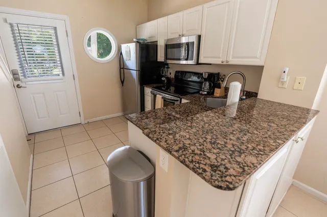 a kitchen with stainless steel appliances granite countertop a sink stove and cabinets