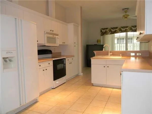 a kitchen with stainless steel appliances a sink and a refrigerator