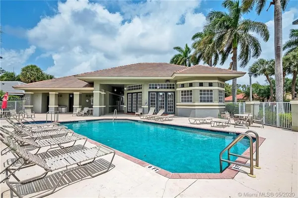 a view of a house with swimming pool and sitting area