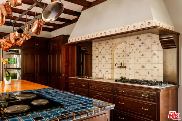a kitchen with stainless steel appliances granite countertop a sink and wooden floors