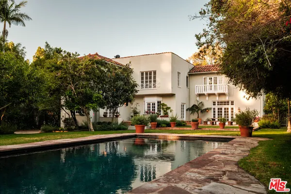 a house view with swimming pool and sitting space