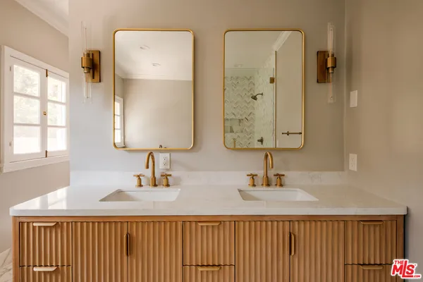 a bathroom with a granite countertop toilet sink and mirror