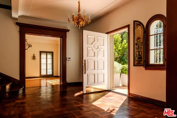 a view of empty room with a fireplace and wooden floor