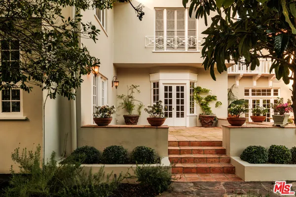 a view of a house with swimming pool and sitting area