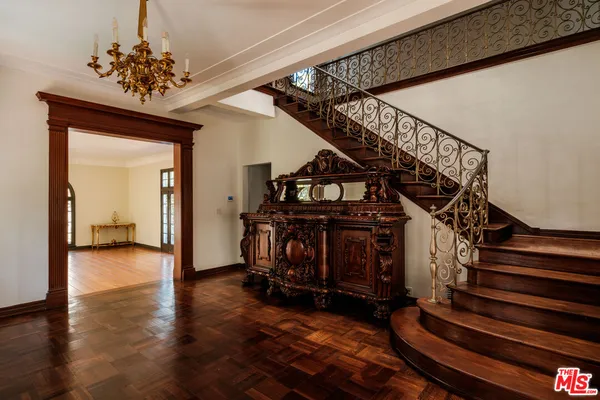 a view of entryway bedroom and hall with wooden floor
