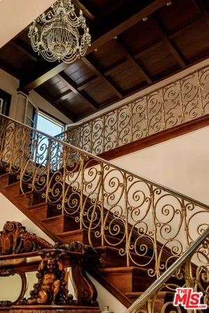 a view of empty room with window and wooden floor