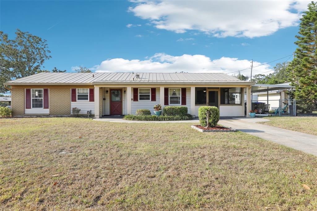 2314 Falkner Road Orlando, FL 32810 - Photo 1 of 1 a front view of a house with a yard and potted plants