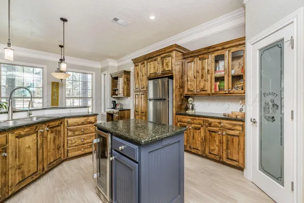 a large kitchen with granite countertop a sink counter space appliances and a large window