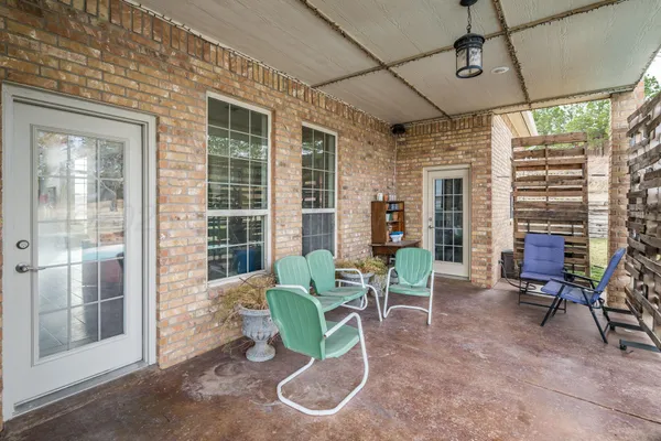 a view of a patio with couches chairs and potted plants