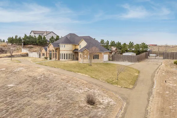 an aerial view of a house with swimming pool and lake view
