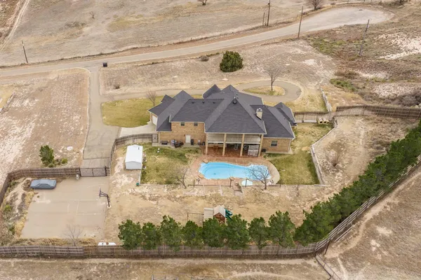 an aerial view of residential houses with outdoor space