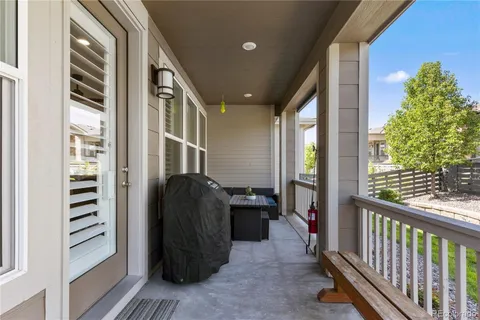 a view of a balcony with chair and front door