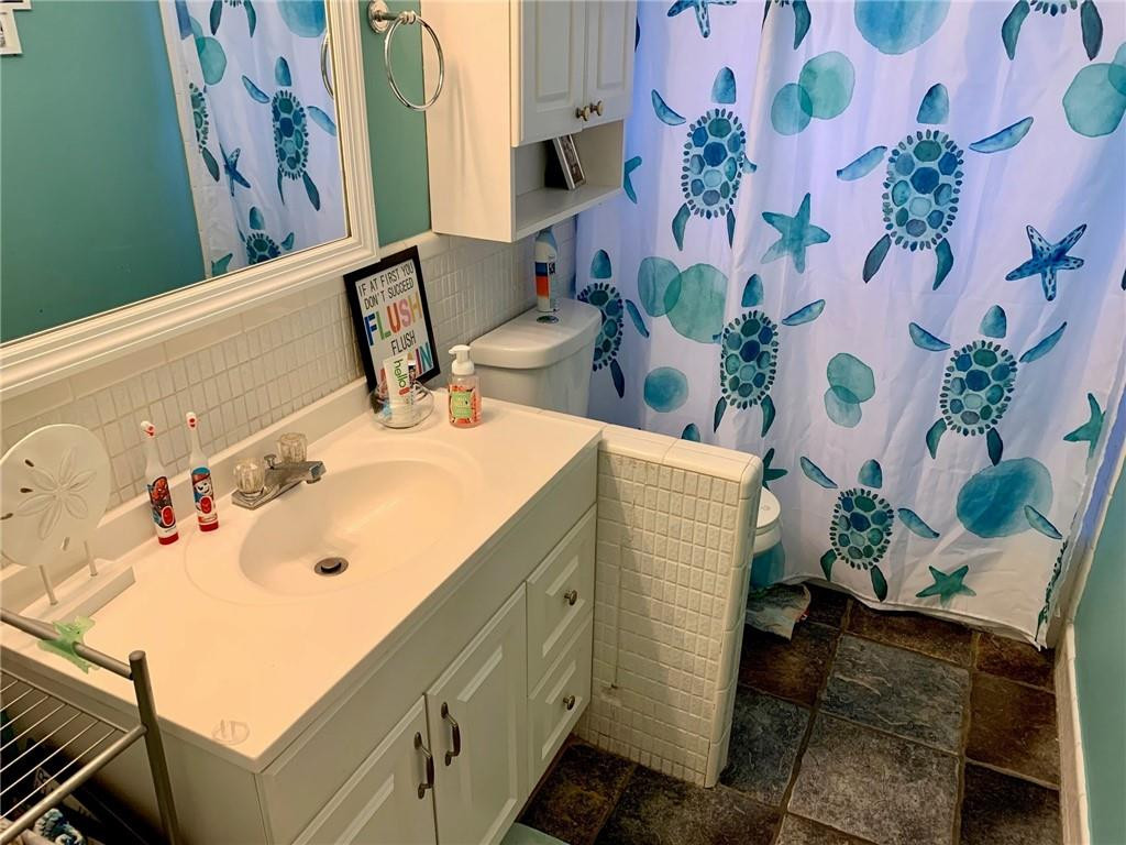 5261 Southwest 7th Street Margate, FL 33068 - Photo 11 of 17 a bathroom with a sink and mirror with bathtub