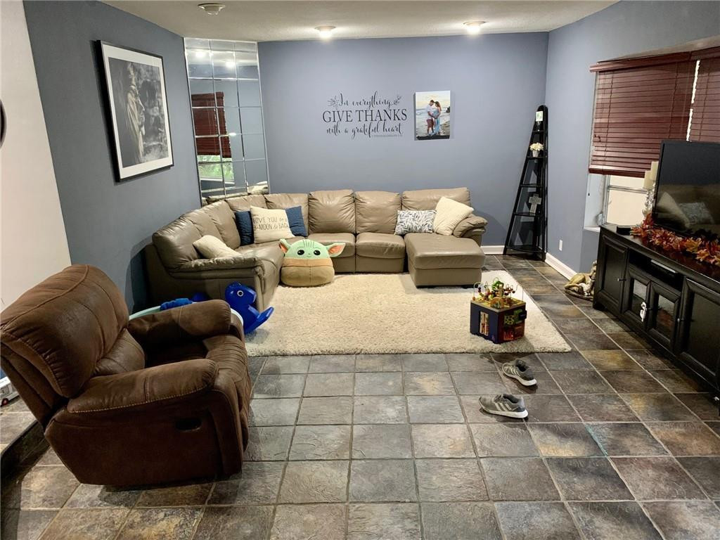 5261 Southwest 7th Street Margate, FL 33068 - Photo 2 of 17 a living room with furniture and a flat screen tv
