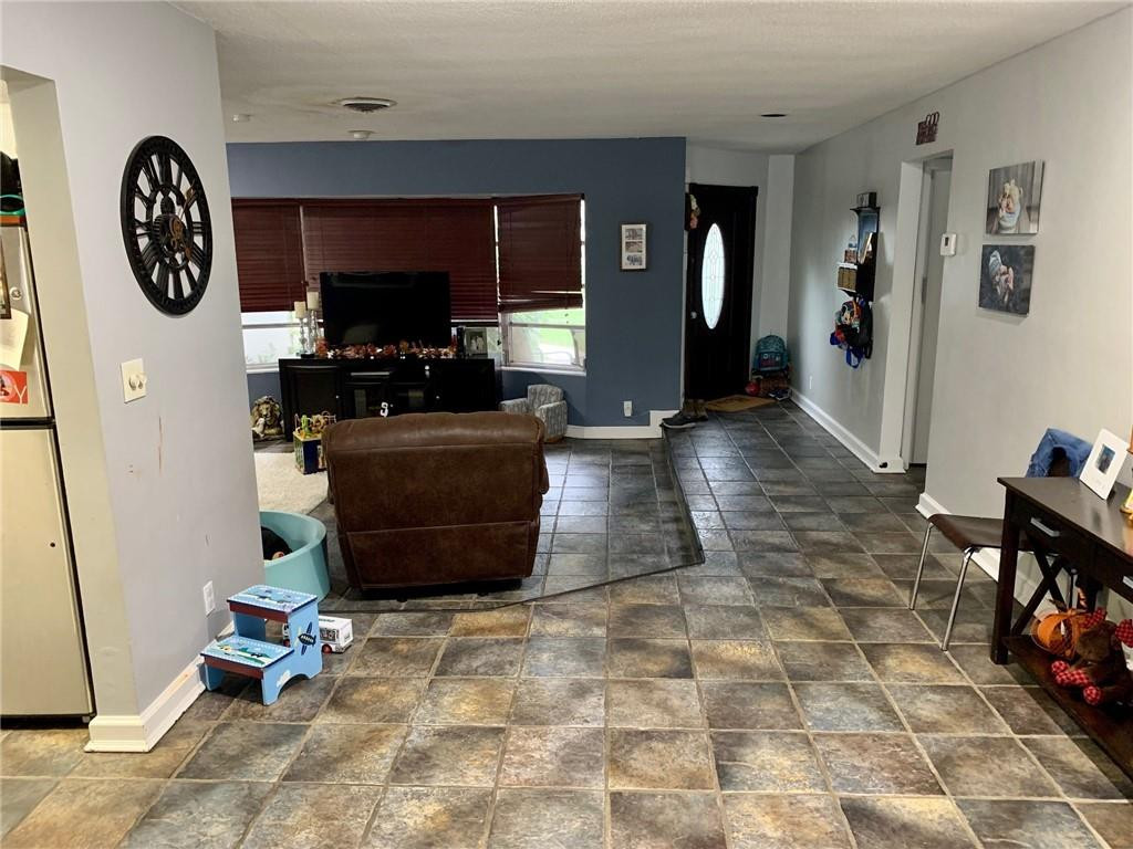 5261 Southwest 7th Street Margate, FL 33068 - Photo 6 of 17 a living room with furniture and a flat screen tv