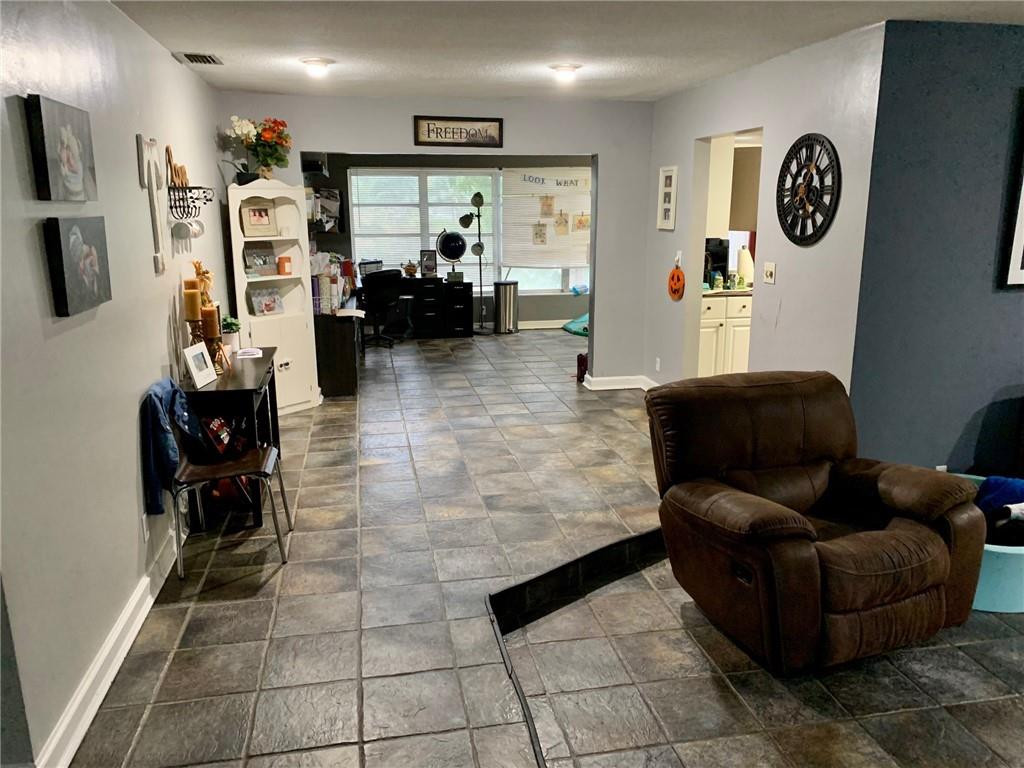 5261 Southwest 7th Street Margate, FL 33068 - Photo 7 of 17 a living room with furniture and a flat screen tv