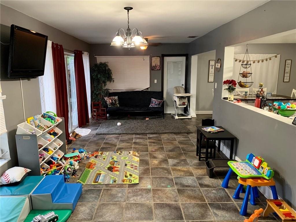 5261 Southwest 7th Street Margate, FL 33068 - Photo 9 of 17 a living room filled with furniture and a flat screen tv