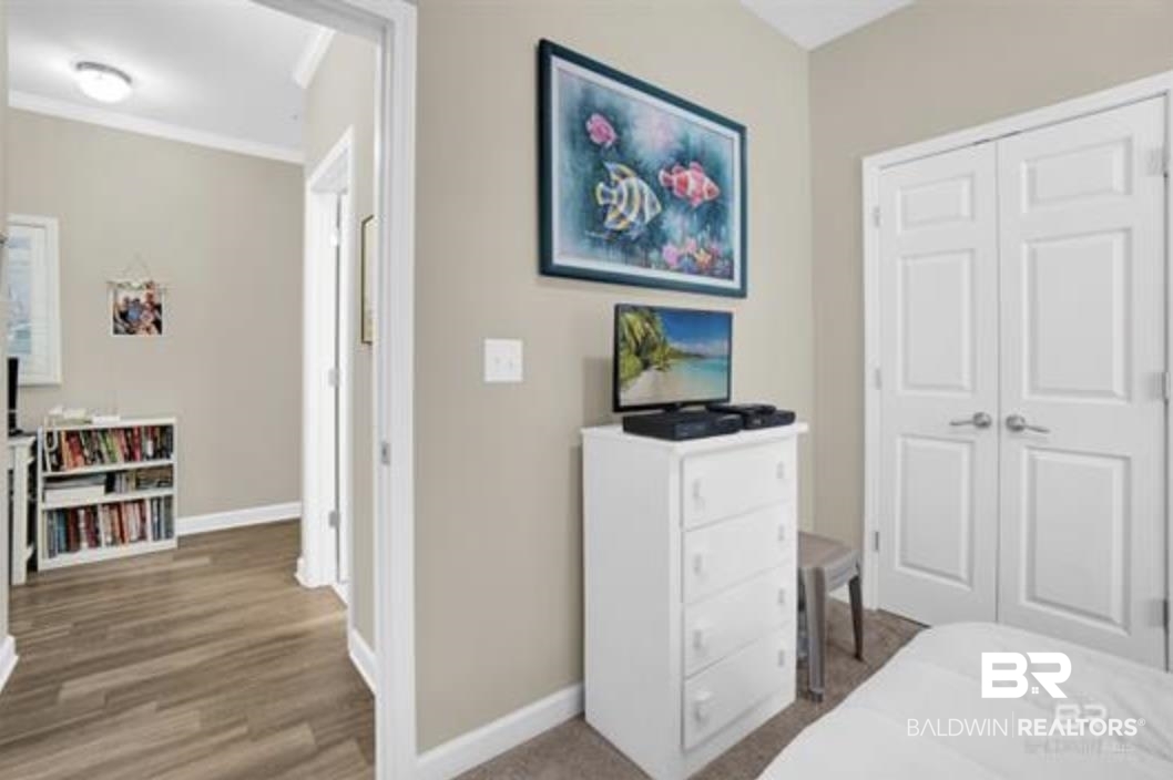 430 West Fort Morgan Road Gulf Shores, AL 36542 - Photo 18 of 27 Bedroom space featuring neutral wall tones, carpet flooring, and white double-panel closet doors