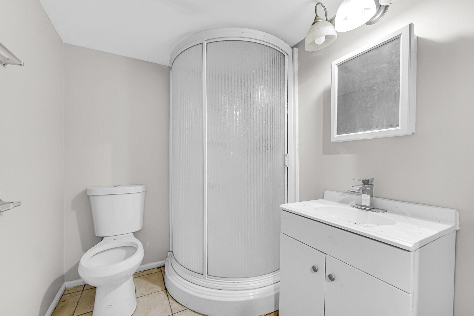 6220 Garfield Avenue Hammond, IN 46324 - Photo 16 of 20 a bathroom with a toilet sink and a mirror