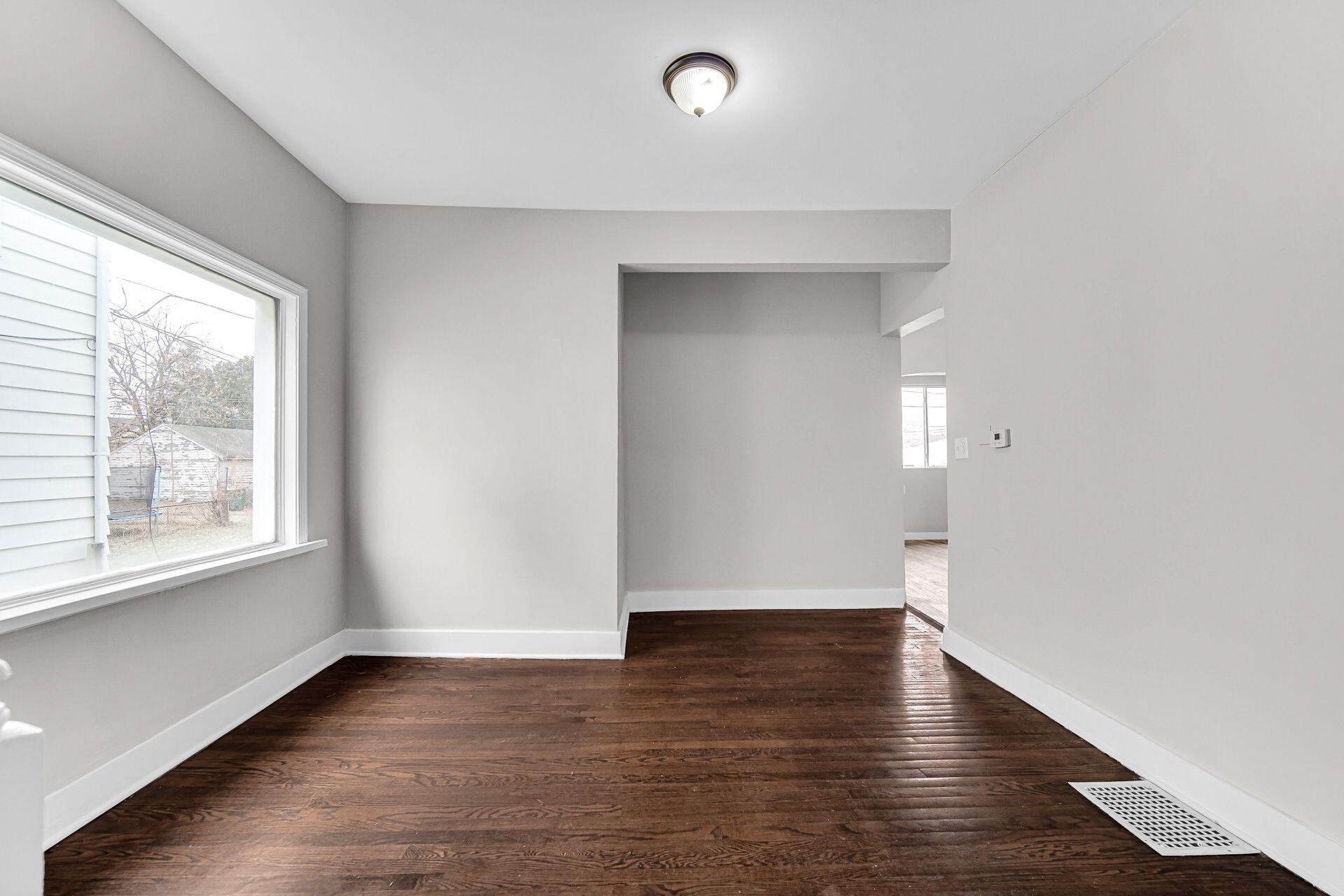 6220 Garfield Avenue Hammond, IN 46324 - Photo 7 of 20 an empty room with wooden floor and windows