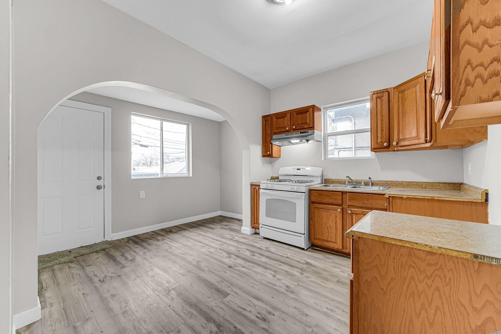 6220 Garfield Avenue Hammond, IN 46324 - Photo 10 of 20 a kitchen with granite countertop a stove cabinets and wooden floor