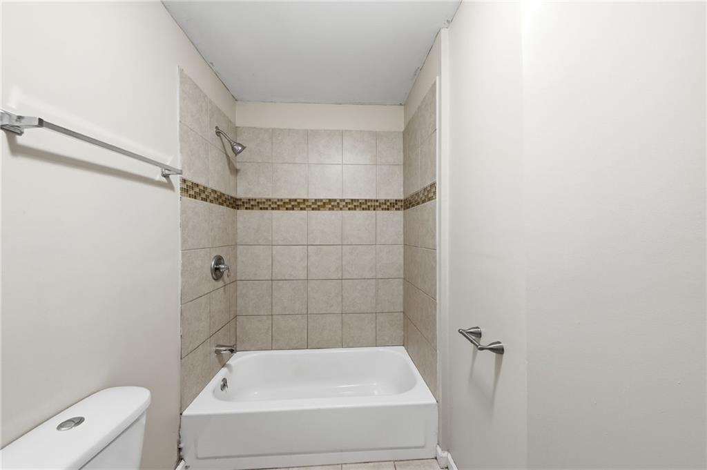 94 Ericson Street Southeast Atlanta, GA 30317 - Photo 26 of 39 a bathroom with a bathtub and shower