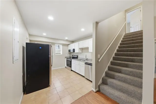a view of kitchen with refrigerator and microwave