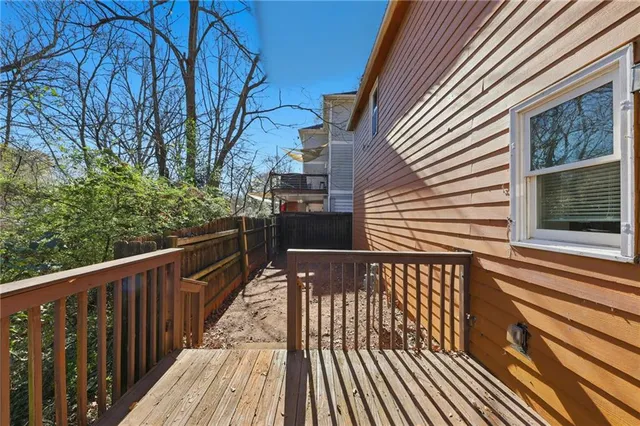 a view of a balcony with wooden floor and fence