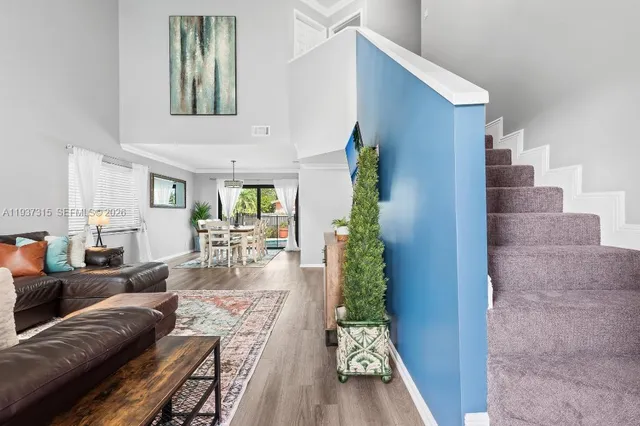 a living room with furniture and a entryway